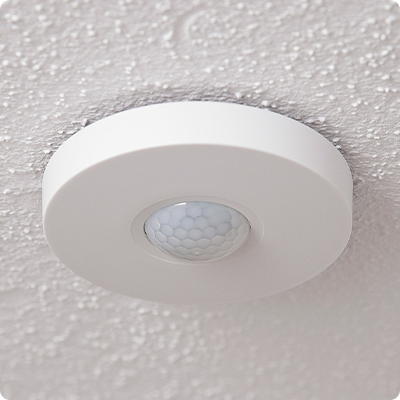 Sensors PIR celing sensor mounted on white platered ceiling