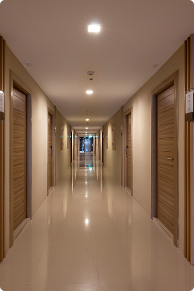 downlights providing ambient lighting in hotel corridor