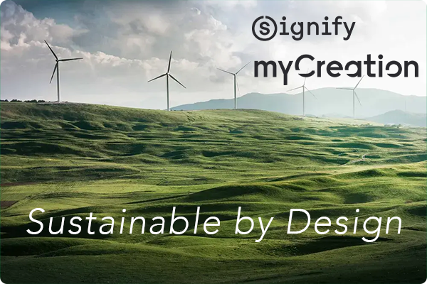 image of green field with a wind farm in the background